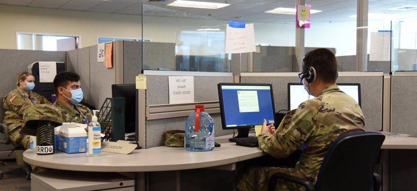 Members of the Arizona National Guard conduct exposure notifications from a call center on June 30 as part of contact tracing efforts.