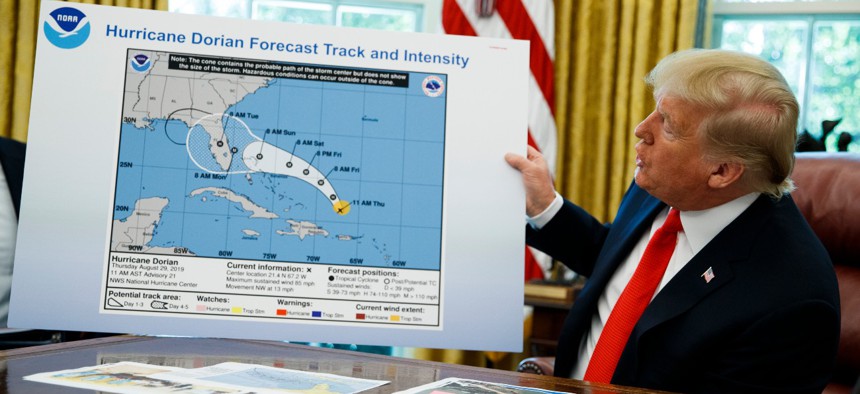 President Trump holds a chart as he talks with reporters on Sept. 4, 2019 after receiving a briefing on Hurricane Dorian. 