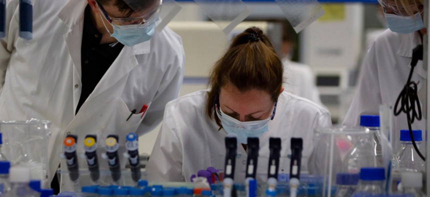 Lab technicians speak with each other during research on coronavirus, COVID-19, at Johnson & Johnson subsidiary Janssen Pharmaceutical in Beerse, Belgium on June 17.