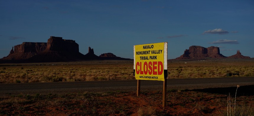 A sign posted in Oljato-Monument Valley, Utah, says the Navajo Monument Vally Tribal Park is closed, in an effort to prevent the spread of COVID-19 on the Navajo reservation.