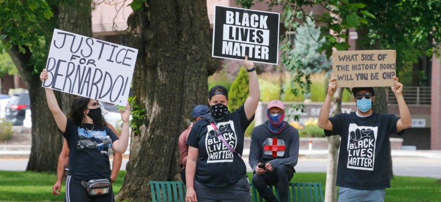 Black Lives Matter supporters look on as Utah Business Revival hosts a "Blue Rally" to support men and women of law enforcement and Utah's small businesses Saturday, June 20, 2020, in Salt Lake City.