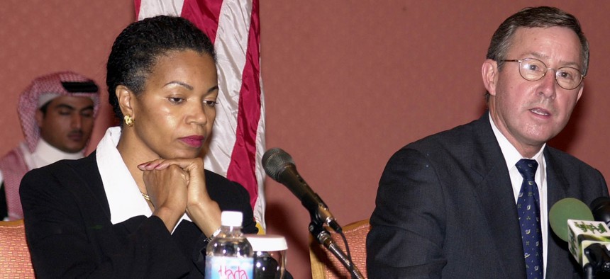 U.S. Consul General in Jiddah, Saudi Arabia, Gina Abercrombie-Winstanley, left, listens as the U.S. Ambassador to Saudi Arabia, James C. Oberwetter, right, addresses reporters in 2004.