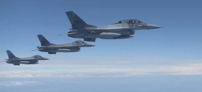 Three Romanian F-16s fly alongside a U.S. Air Force KC-135 Stratotanker assigned to the 100th Air Refueling Wing, England, over Romania July 22, 2020.