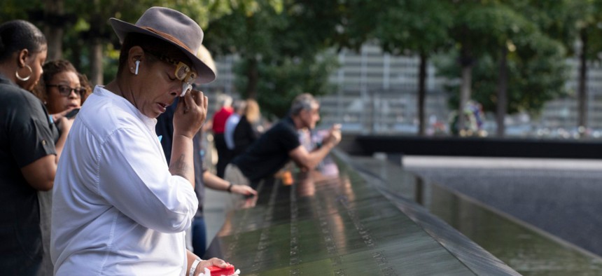 People mourn near the National September 11 Memorial in New York in September, 2019.