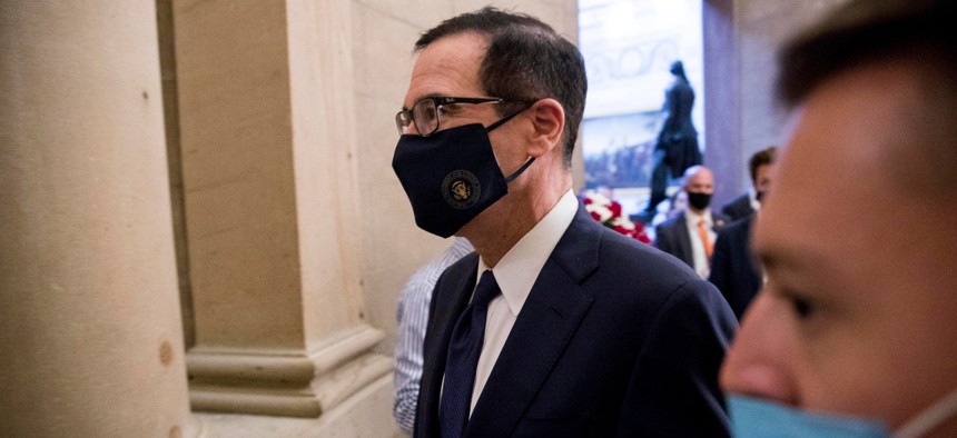 Treasury Secretary Steven Mnuchin walks into a meeting on Capitol Hill on July 29. Some say the terms of the USPS loan, signed by Mnuchin, will allow undue political influence over the mailing agency. 