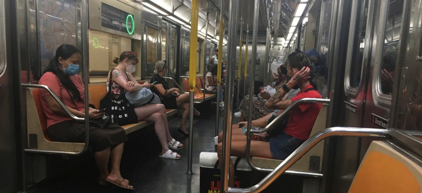 Subway riders wear masks in New York on July 20.