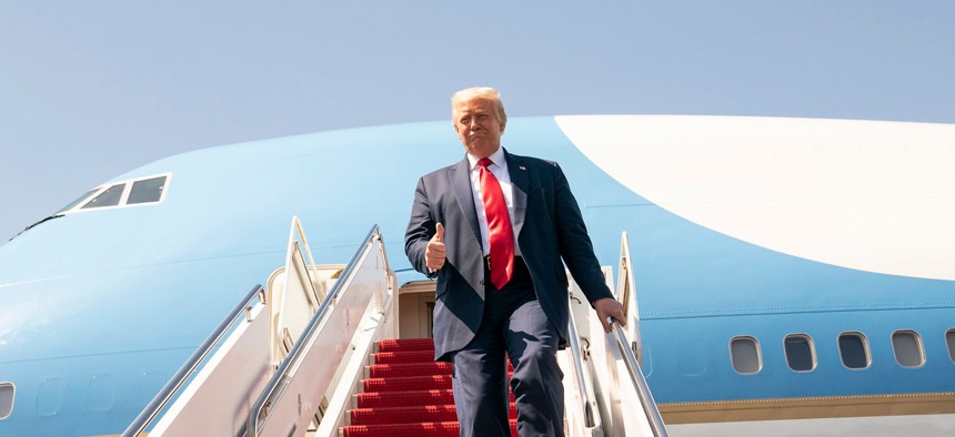 President Trump gives a thumbs-up as he disembarks Air Force One at Tampa International Airport in Tampa, Fla. Friday, July 31, 2020.