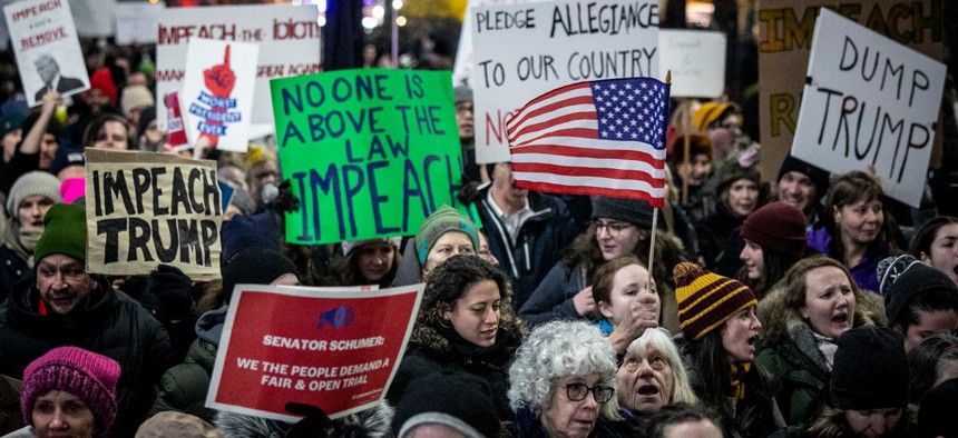 An anti-President Trump crowd gathers at a rally in New York to protest and call for his impeachment in December 2019. 