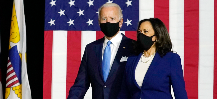 Democratic presidential candidate former Vice President Joe Biden and his running mate Sen. Kamala Harris, D-Calif., arrive to speak at a news conference at Alexis Dupont High School in Wilmington, Del., on Wednesday. 