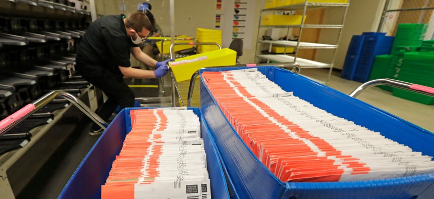 Vote-by-mail ballots are shown in sorting trays at the King County Elections headquarters in Renton, Wash., south of Seattle, on Aug. 5. 
