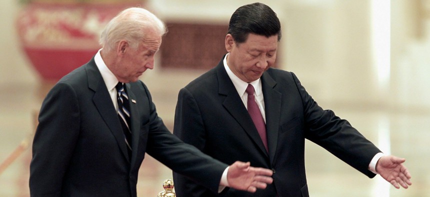 Then-Chinese Vice President Xi Jinping, right, invites his U.S. counterpart Joseph Biden to review an honor guard during a welcoming ceremony inside the Great Hall of the People on Thursday, Aug. 18, 2011 in Beijing. 