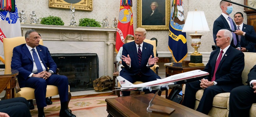 President Trump meets with Iraqi Prime Minister Mustafa al-Kadhimi in the Oval Office of the White House on Thursday. Sitting at right is Vice President Mike Pence. 