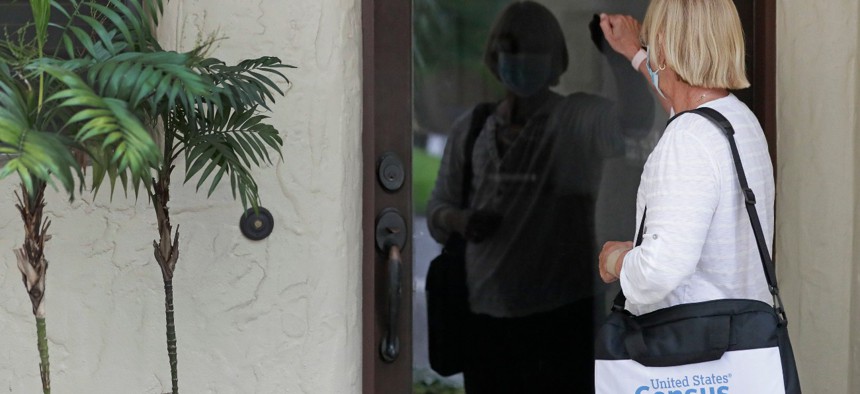 A census taker knocks on the door of a residence on Aug. 11 in Winter Park, Fla. 