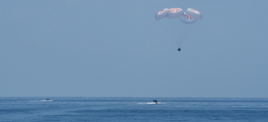 The SpaceX Crew Dragon Endeavour spacecraft lands with NASA astronauts Robert Behnken and Douglas Hurley onboard in the Gulf of Mexico off the coast of Pensacola, Fla., on Aug. 2.