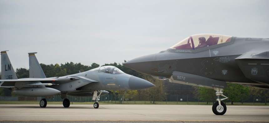 An F-35A Lightning II from the 34th Fighter Squadron at Hill Air Force Base, and an F-15C Eagle from the 493rd Fighter Squadron, stand by to take-off for a training sortie at Royal Air Force Lakenheath, England. 