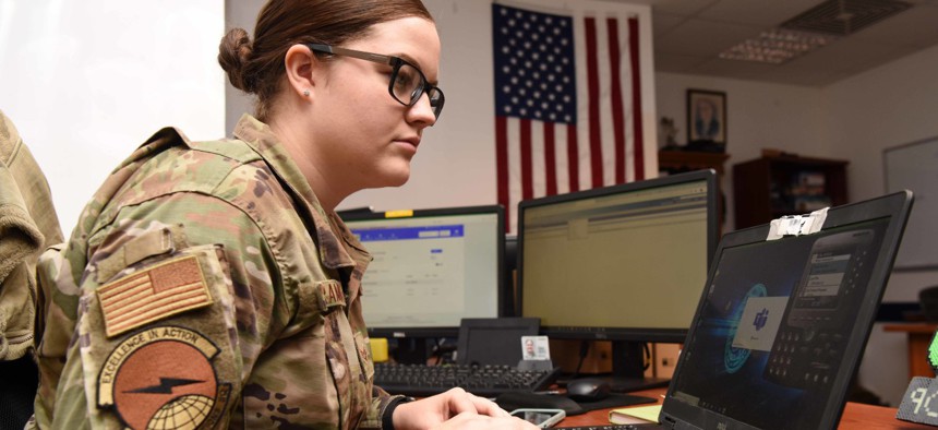 U.S. Air Force Senior Airman Kaitlyn Schramek, 39th Communications Squadron voice systems technician, troubleshoots a voice communicator app at Incirlik Air Base, Turkey. Voice systems technicians ensure voice communications are accessible for telework. 