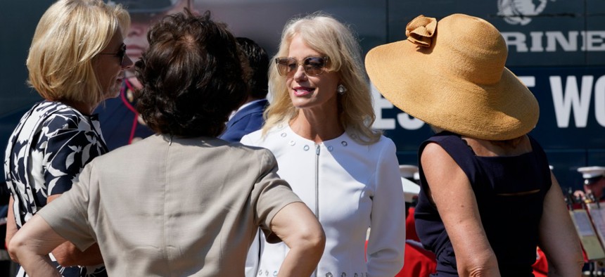 Kellyanne Conway, speaks with Education Secretary Betsy Devos, left, and Transportation Secretary Elaine Chao, second from left, at an event with First Lady Melania Trump, in front of the White House. (