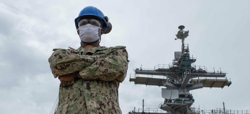 Fire Controlman 3rd Class Bismark Diaw, assigned to the combat systems department aboard the Nimitz-class aircraft carrier USS George Washington (CVN 73), stands on the flight deck of the ship in June. 
