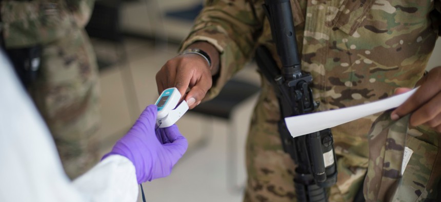Soldiers attached to the Texas Army National Guard's 36th Infantry Division and 272th Engineer Company receive an COVID-19 IgG, IgM antigen test at Camp Swift in Bastrop, Texas, in June. 