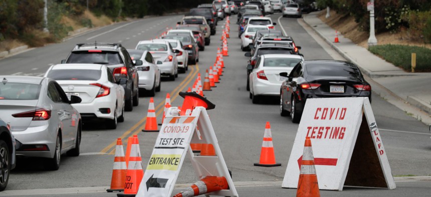 Motorists line up at a coronavirus testing site at Dodger Stadium in Los Angeles in June.