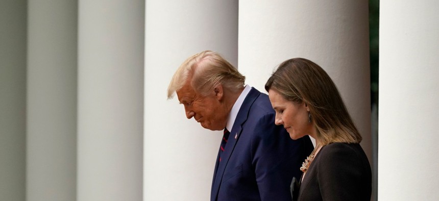 President Trump walks with Judge Amy Coney Barrett to a news conference to announce Barrett as his nominee to the Supreme Court, in the Rose Garden at the White House on Sept. 26.