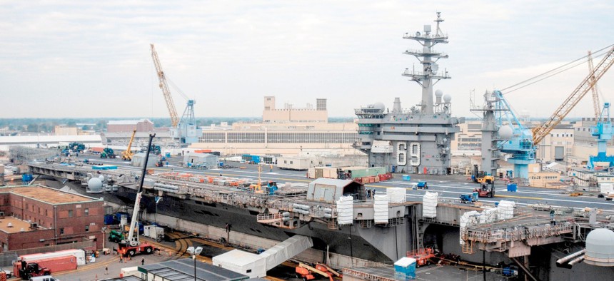 The aircraft carrier USS Dwight D. Eisenhower (CVN 69) sits in dry dock during a 14-month scheduled docking planned incremental availability at Norfolk Naval Shipyard. 
