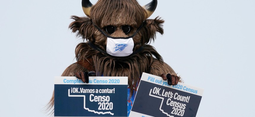 Rumble, the mascot of the Oklahoma City Thunder NBA basketball team, holds signs encouraging participation in the U.S. Census, at a drive-thru Census Mobile Questionnaire Assistance (MQA) event outside the state Capitol in Oklahoma City in September.