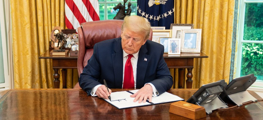 Presidents have used executive authority to advance policy agendas in the absence of Congressional support. Above, President Trump signs an executive order in June directing federal agencies to bypass environmental restrictions in the permitting process.
