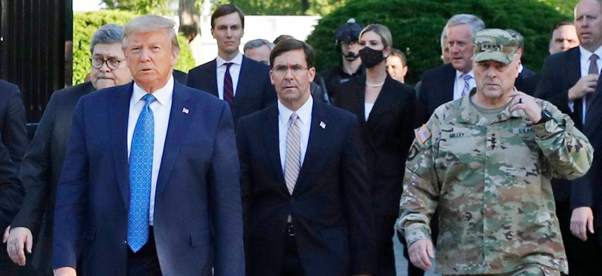 President Trump departs the White House to visit outside St. John's Church in June. Walking behind Trump from left are, Attorney General William Barr, Defense Secretary Mark Esper and Gen. Mark Milley, chairman of the Joint Chiefs of Staff.