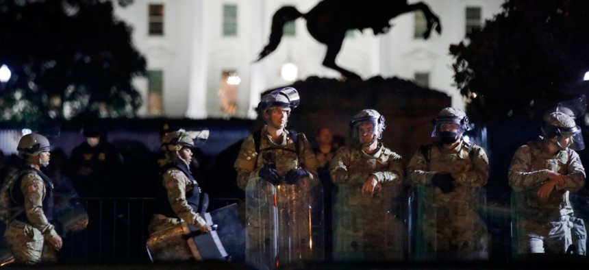 DC National Guard members stand in Lafayette Park as demonstrators gather June 2 to protest the death of George Floyd.