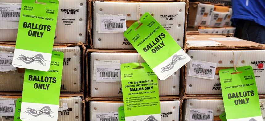 Boxes in the first batch of 111,000 mail-in ballots are tagged and ready to ship from the Douglas County Election Commission's office to the post office, in Omaha, Neb., in September.