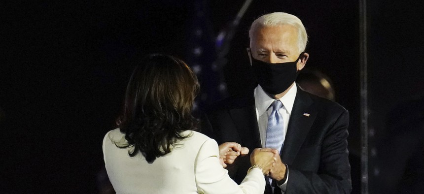 President-elect Joe Biden is greeted on stage by Vice President-elect Kamala Harris before his speech on Saturday.