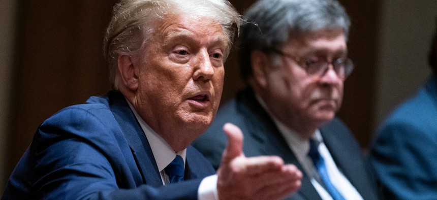 Attorney General William Barr listens as President Donald Trump speaks during a meeting with Republican state attorneys general at the White House on Sept. 23, 2020.