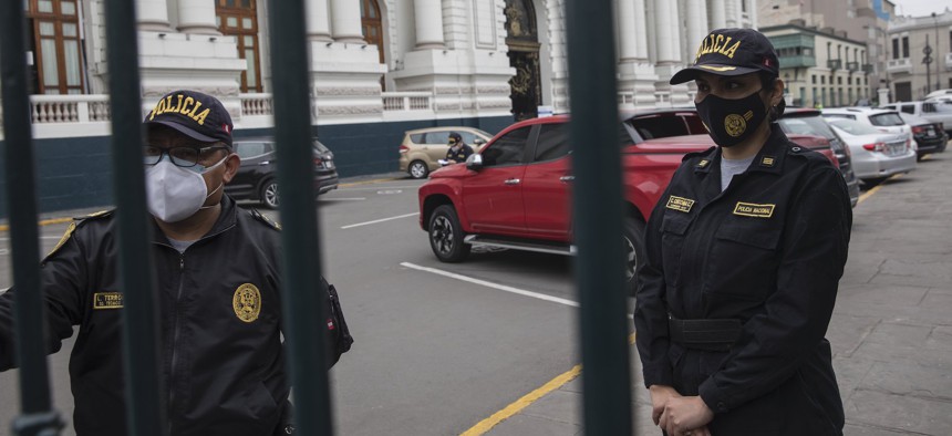 Police stand guard outside Congress in Lima in September.