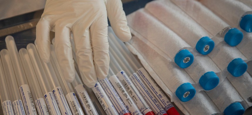 An aid worker from the Spanish NGO Open Arms touches coronavirus detection test kits at a nursing home in Barcelona, Spain. 
