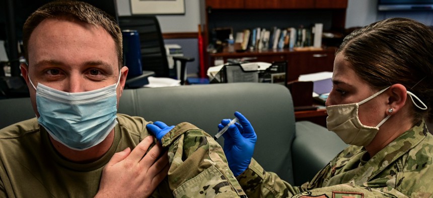 Senior Airman Kara Sweeney, 911th Aeromedical Staging Sqadron aeromedical technician, administers an influenza vaccination to Tech. Sgt. Richard Kaulfers, 911th Airlift Wing broadcast journalist, in September. 