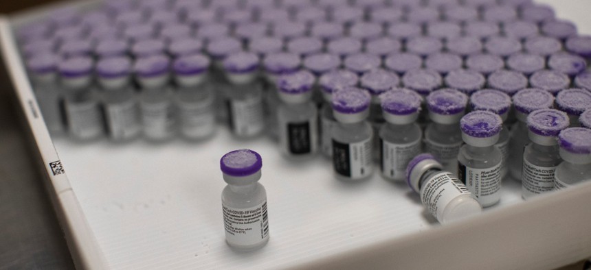 Frozen vials of the COVID-19 vaccine are taken to be defrosted and ready to be usable, at the MontLegia CHC hospital in Liege, Belgium, on Monday. 