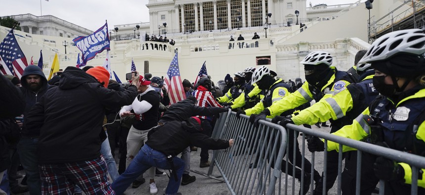 Trump supporters try to break through a police barrier on Wednesday at the Capitol.