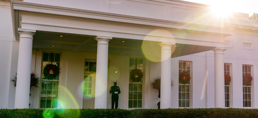 A Marine stands outside the entrance to the West Wing of the White House, signifying the President is in the Oval Office, Tuesday, Dec. 22, 2020.