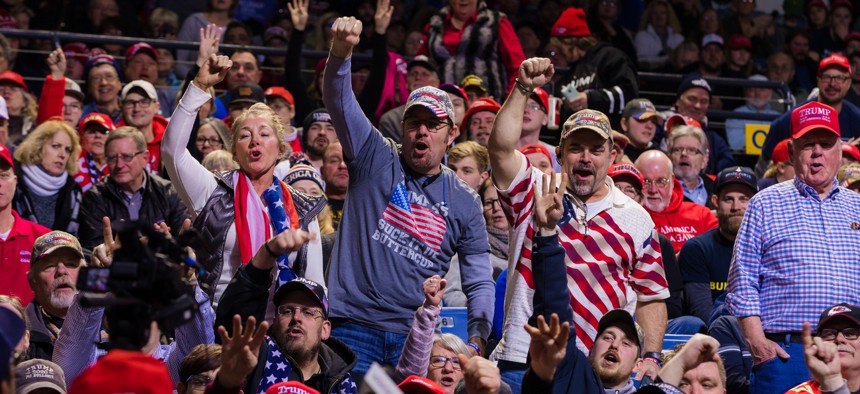 Trump supporters wait for the president's arrival at a rally in January 2020 in Iowa.
