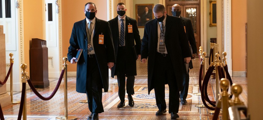 Security officials survey the Capitol on Monday, ahead of the scheduled presidential inauguration. 