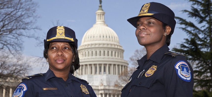 Yogananda Pittman, left, photographed here with fellow Capitol Police officer Monique Moore, right, in 2012. Pittman was appointed to head the Capitol Police force in January 2021, after a riot at the Capitol prompted the resignation of the previous chief