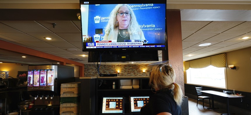 Waitress Lauren Musial watches a television briefing by Pennsylvania Health Secretary, Dr. Rachel Levine, at the Penrose Diner, Tuesday, Nov. 17, in South Philadelphia.