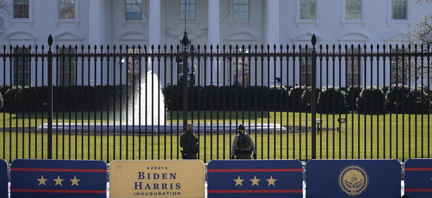 A security team patrols in front of the White House as preparations continue ahead of President-elect Joe Biden's inauguration ceremony on Tuesday.