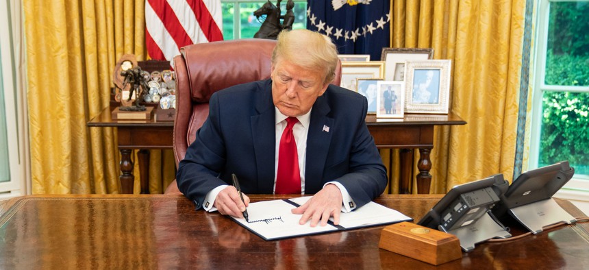 President Donald J. Trump signs an executive order on expediting permitting in June.