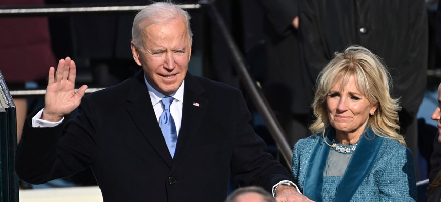 Joe Biden is sworn in as the 46th president of the United States by Chief Justice John Roberts as Jill Biden holds the bible during the 59th Presidential Inauguration on Wednesday. 