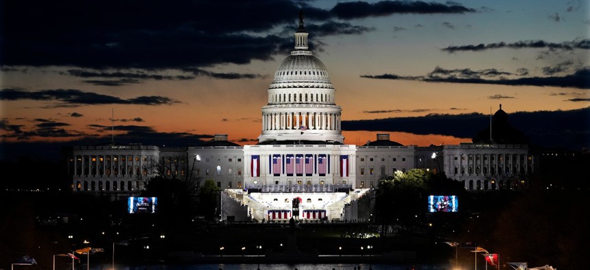 Capitol Building and stage for the swearing-in is lit as events get underway for President-elect Joe Biden's inauguration ceremony, Wednesday, Jan. 20, 2021, in Washington. 