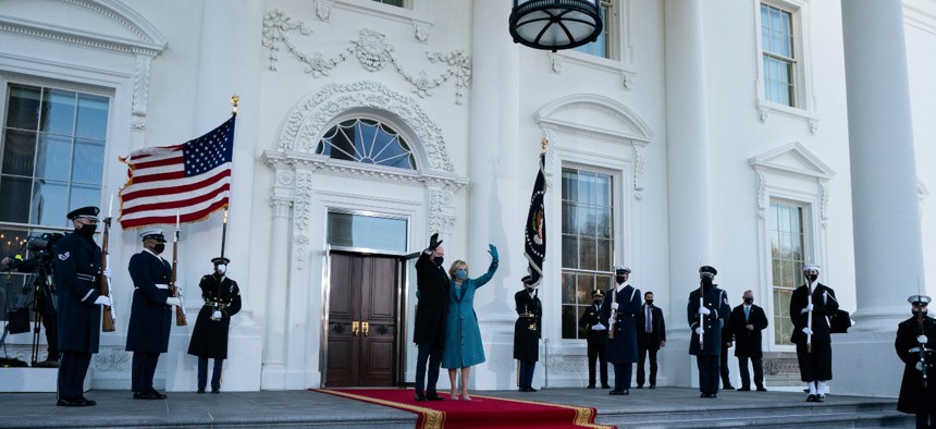 President Joe Biden and first lady Jill Biden wave as they arrive at the North Portico of the White House, Wednesday, Jan. 20, 2021, in Washington.