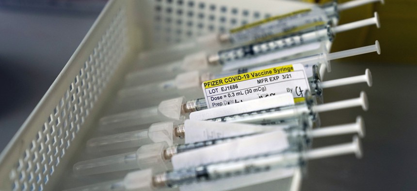 Syringes containing the Pfizer-BioNTech COVID-19 vaccine sit in a tray in a vaccination room at St. Joseph Hospital in Orange, Calif. on Jan. 7.