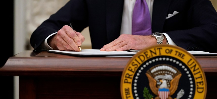 President Biden has signed a flurry of executive orders since taking office. Above, he signs executive orders after speaking about the coronavirus in the State Dinning Room of the White House, Thursday, Jan. 21, 2021, in Washington.